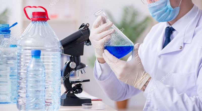 The young male chemist experimenting in lab